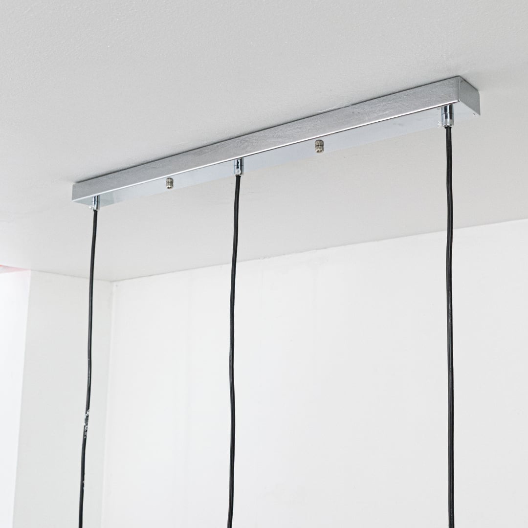 Silver metal linear canopy with suspended cords highlighting sleek modern craftsmanship and finish.