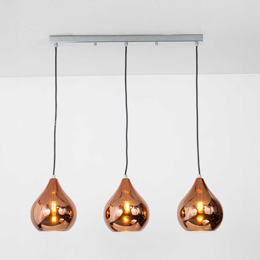 Amber glass pendant lights with metallic finish designed for elegant contemporary home decor spaces.