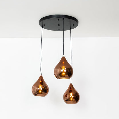 Amber glass pendant lights with metallic finish designed for elegant contemporary home decor spaces.