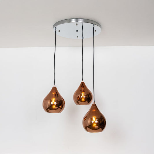 Amber glass pendant lights with metallic finish designed for elegant contemporary home decor spaces.