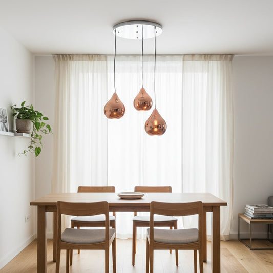 Amber glass pendant lights creating warm ambience above the dining table in modern interior spaces.
