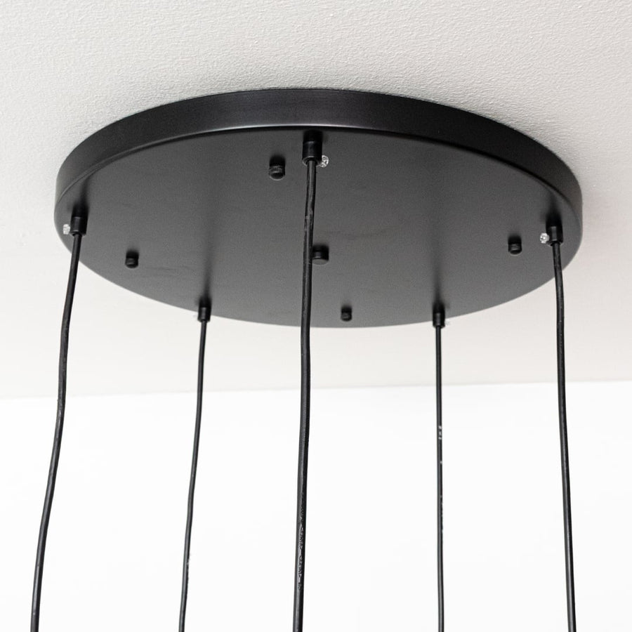 Black metal round ceiling canopy with hanging cords highlighting premium finish and craftsmanship.