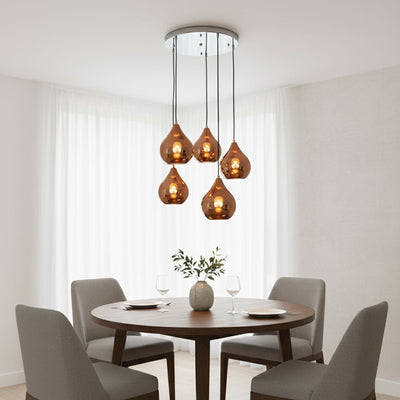 Amber glass pendant lights creating warm ambience above the dining table in modern interiors.