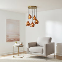 Amber glass pendant lights adding warm elegance to contemporary living room interior spaces.