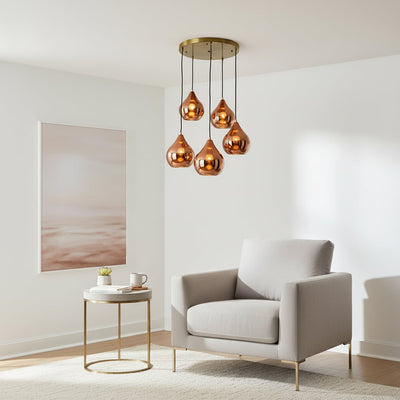 Amber glass pendant lights adding warm elegance to contemporary living room interior spaces.