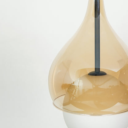 Closeup image of champagne glass pendant light with black stem and artistic flowing glass design.