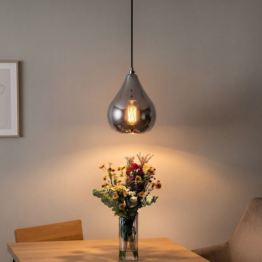 Lifestyle image of chrome droplet single pendant light for elegant kitchen island decor styling and modern home lighting.