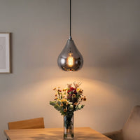 Lifestyle image of chrome droplet single pendant light for elegant kitchen island decor styling and modern home lighting.