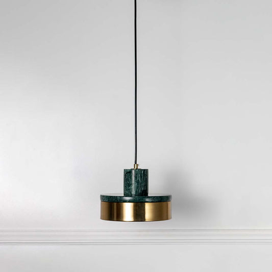 Modern pendant light with green top and gold base hanging against neutral wall background showcasing stylish contemporary lighting decor design.