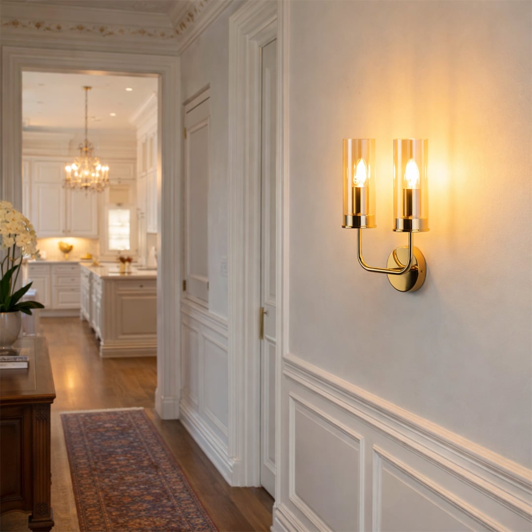 Modern brass wall light with clear glass shades creating warm luxury hallway lighting and elegant interiors.