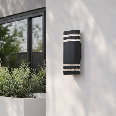 Black metal outdoor LED wall light with horizontal slats for porch entrance and exterior walls with warm lighting.