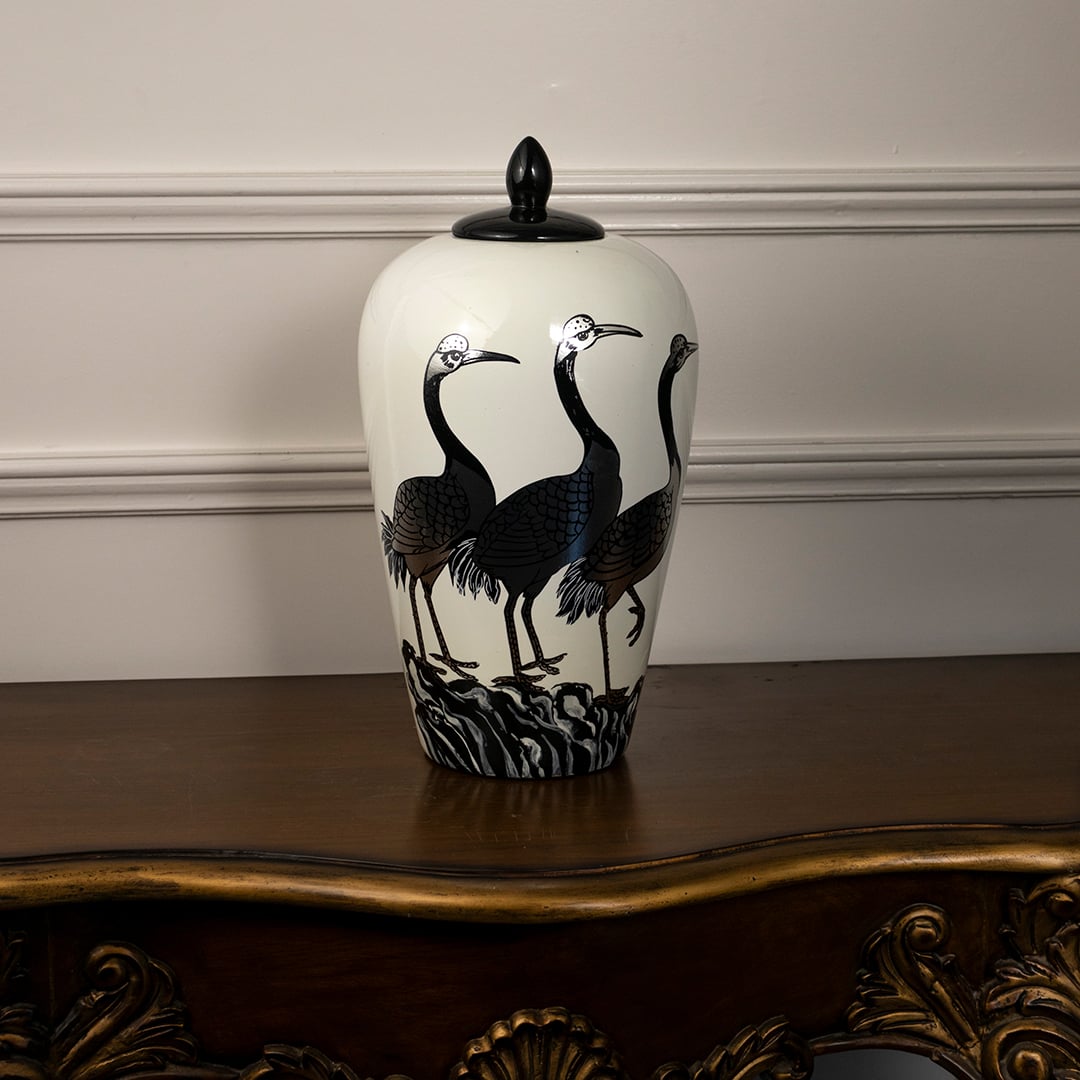 White ceramic jar with black lid featuring elegant crane bird design perfect for classic home or table decoration.