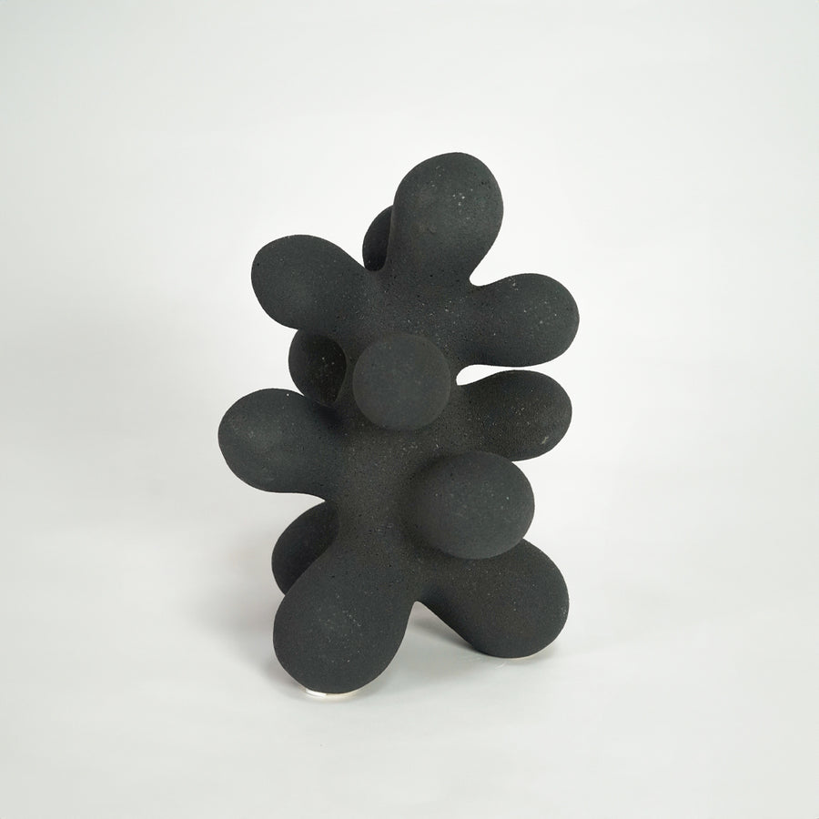 Black modern decor sculpture for artistic coffee table placement and stylish living room decor styling accent piece.