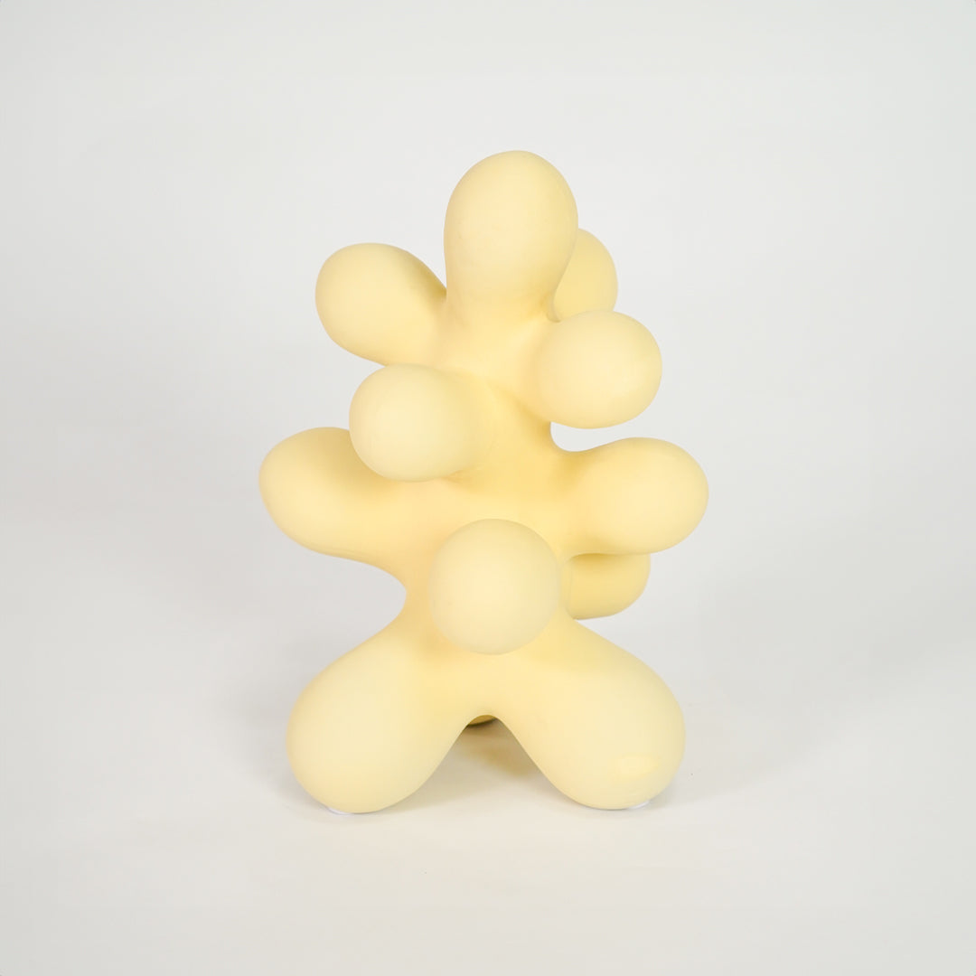 Yellow abstract decor sculpture for stylish shelf placement and modern indoor home decor styling accent piece.