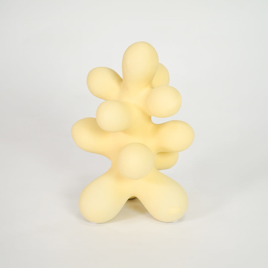 Yellow abstract decor sculpture for stylish shelf placement and modern indoor home decor styling accent piece.