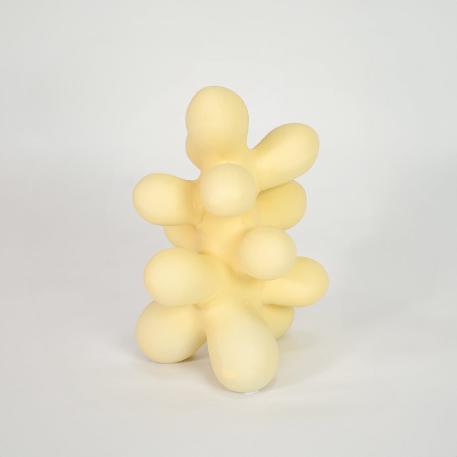 Yellow abstract decor sculpture for modern coffee table placement and artistic indoor home decor styling accent.