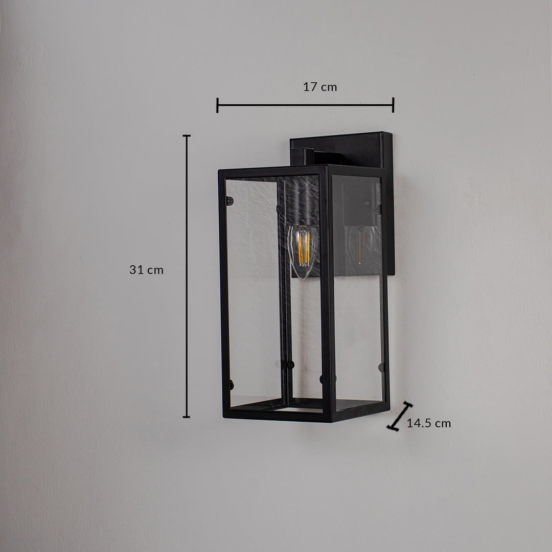 Lantern style black wall light with rectangular glass panels shown on white background measuring 31cm height and 17cm width.