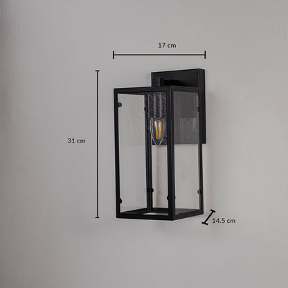 Lantern style black wall light with rectangular glass panels shown on white background measuring 31cm height and 17cm width.