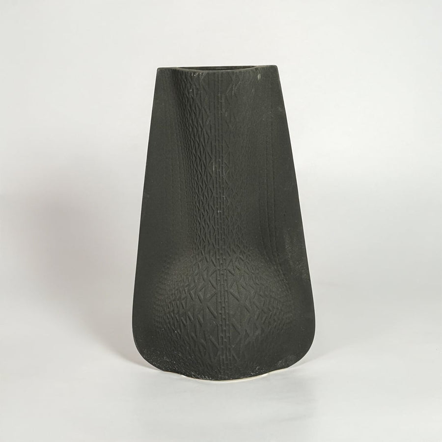 Black decorative ceramic vase on white background modern home decor accent piece for table floor console styling interior.