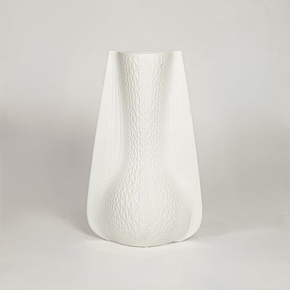 White ceramic decorative vase with soft curved silhouette for minimalist shelf styling and modern home decor.