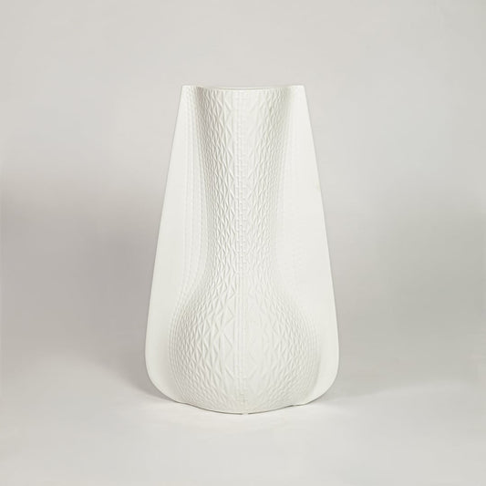 White ceramic decorative vase with soft curved silhouette for minimalist shelf styling and modern home decor.