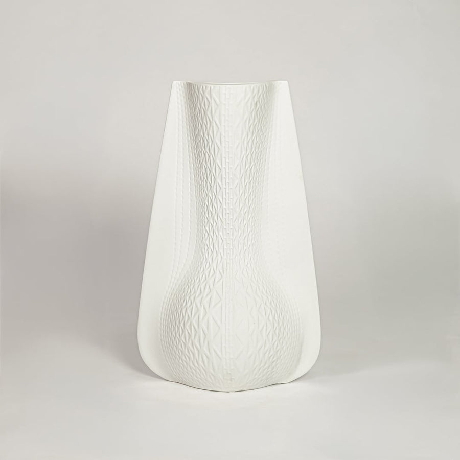 White ceramic decorative vase with soft curved silhouette for minimalist shelf styling and modern home decor.