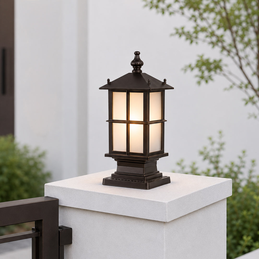 Modern black metal outdoor pillar light for gate entrance garden fence and driveway with warm ambient illumination.