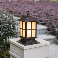 Black metal outdoor gate pillar light for entrance fence garden and driveway with warm ambient landscape lighting.