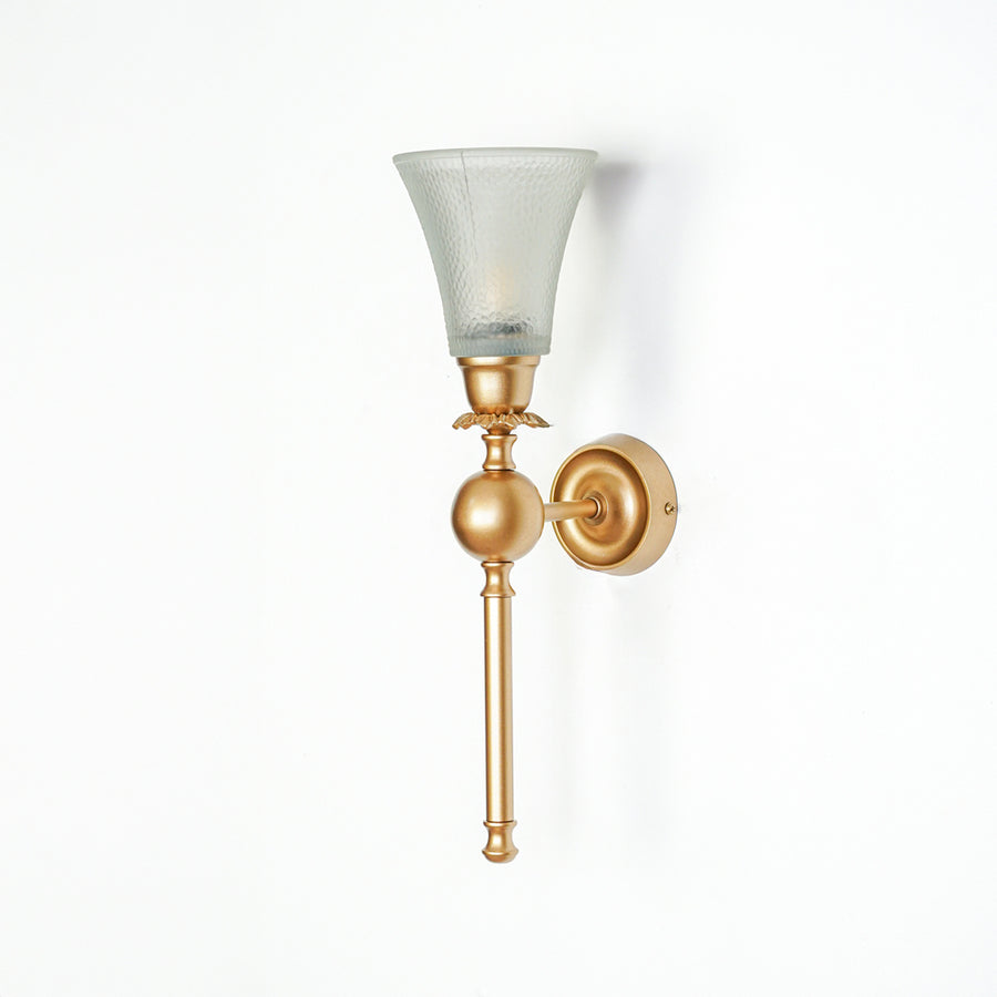 Gold metal wall light with frosted glass shade on white background light off suitable for bedroom hallway and interior decor.