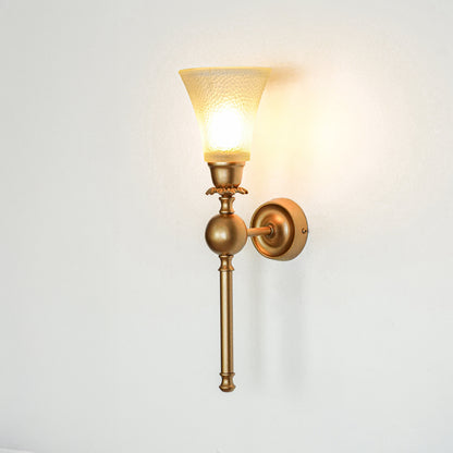Gold metal wall light with frosted glass shade on white background glowing warm ideal for bedroom hallway and living room decor.