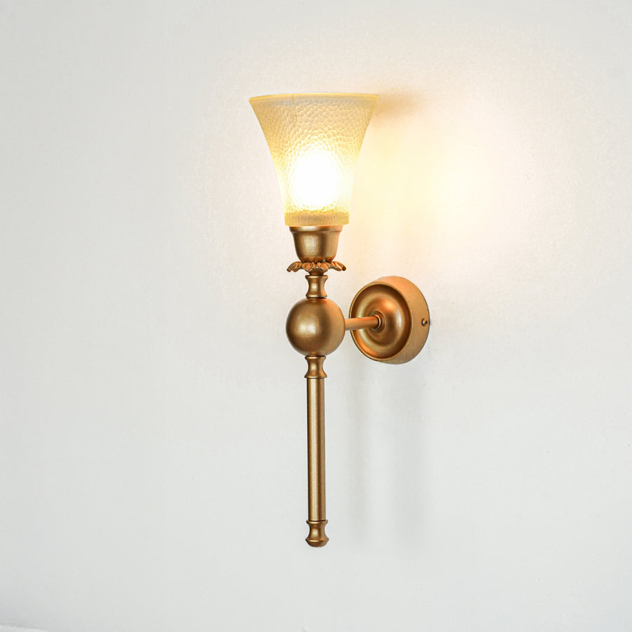Gold metal wall light with frosted glass shade on white background glowing warm ideal for bedroom hallway and living room decor.