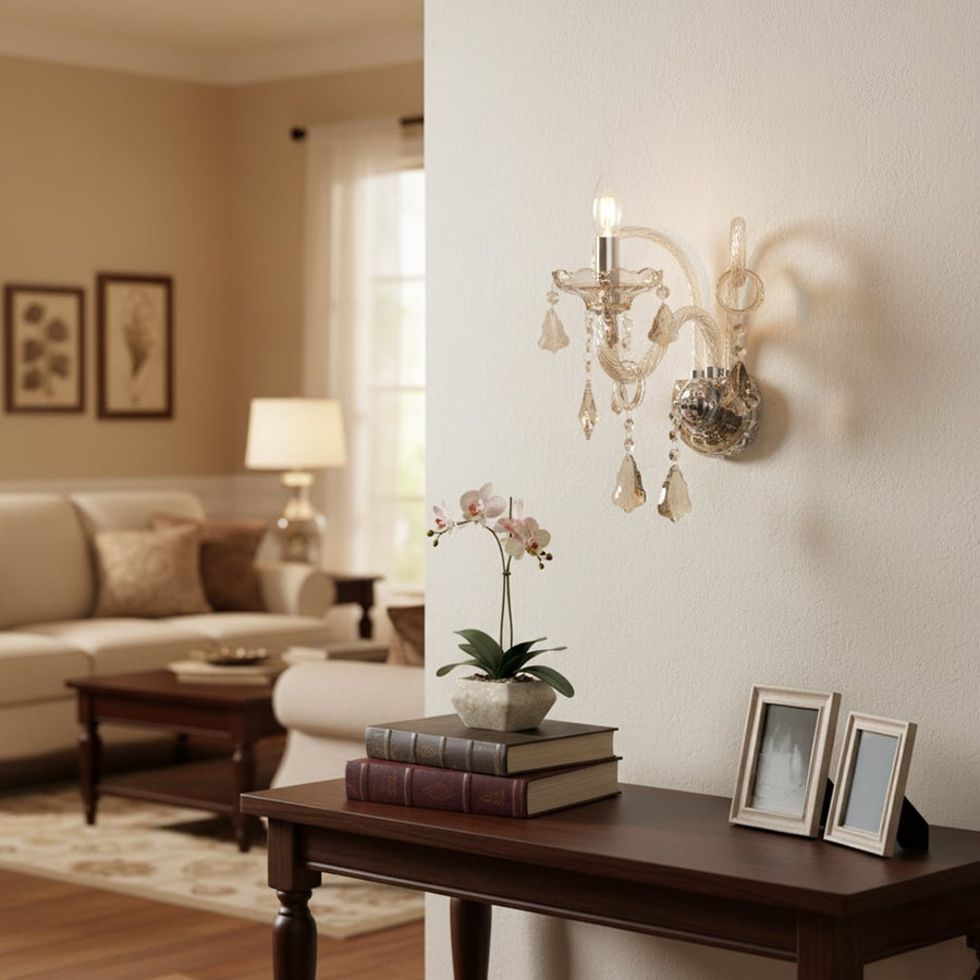 Wall light with champagne glass frame and crystal droplets styled on a soft wall background for elegant warm home lighting.