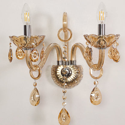 Closeup of golden crystal wall light showing detailed beads and curved arms perfect for luxury home wall lighting.