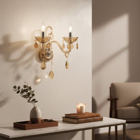 Golden crystal wall light with dual arms and warm glow adds elegant lighting to living room or hallway wall decor.