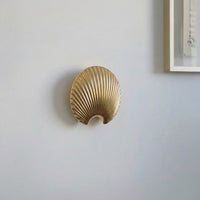 Gold finish metal leaf wall hook with sculpted texture for stylish wall mounting and everyday home organization.