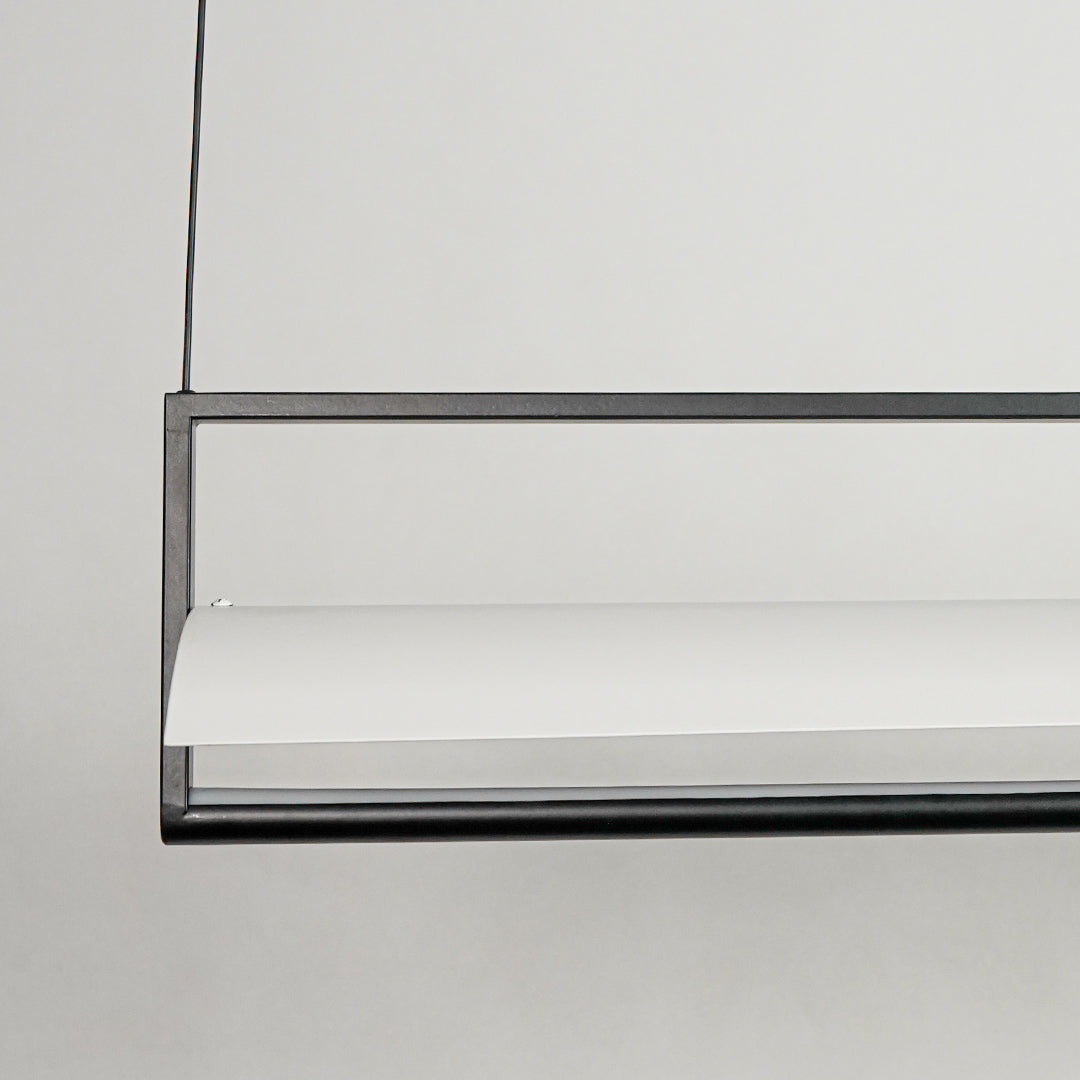 Black linear pendant light with minimalist metal bar design on neutral background ideal for modern interior lighting setup.

