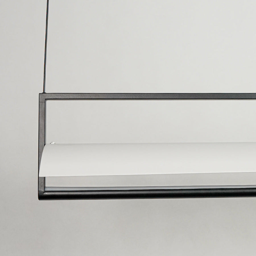 Black linear pendant light with minimalist metal bar design on neutral background ideal for modern interior lighting setup.

