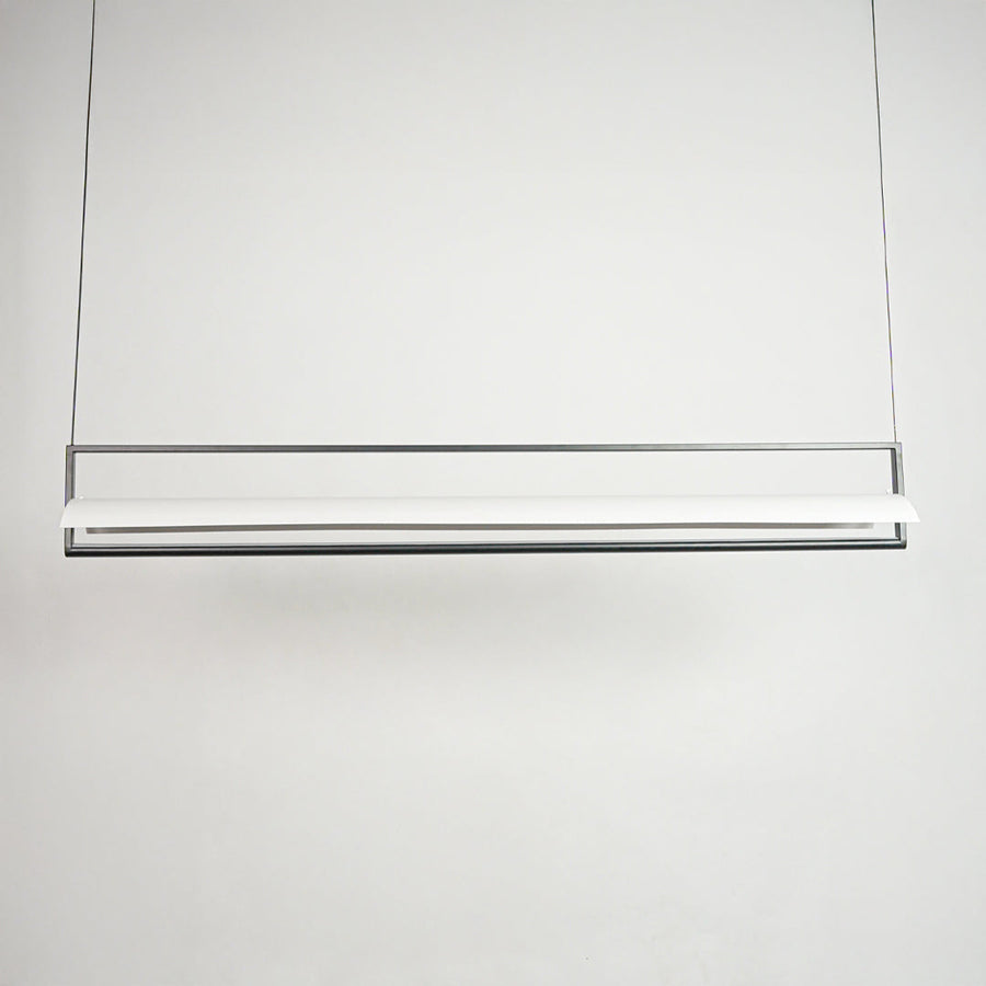 Contemporary linear pendant light with slim bar design suspended in minimal space perfect for stylish home decor lighting.