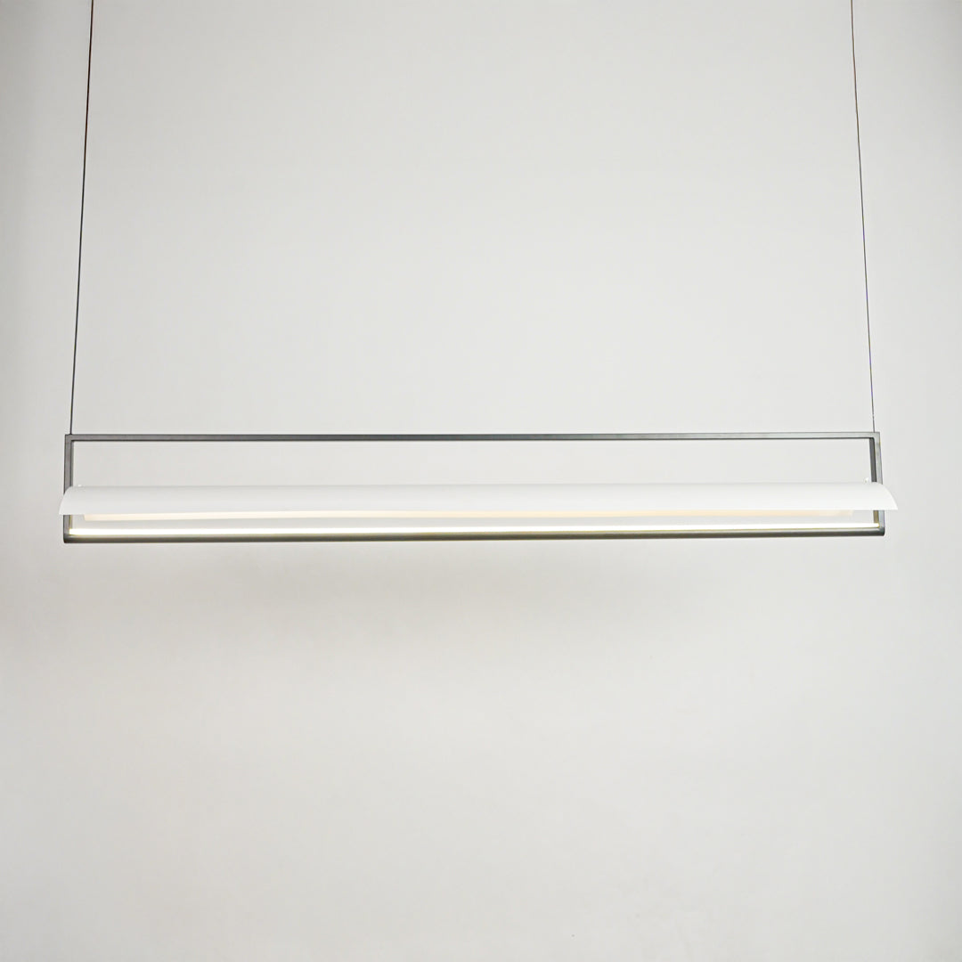 Minimal linear hanging light with sleek metal finish on clean neutral background ideal for modern kitchen or dining lighting.