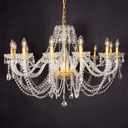 Large gold crystal chandelier shown on black background highlighting premium crystal detailing for elegant interiors.