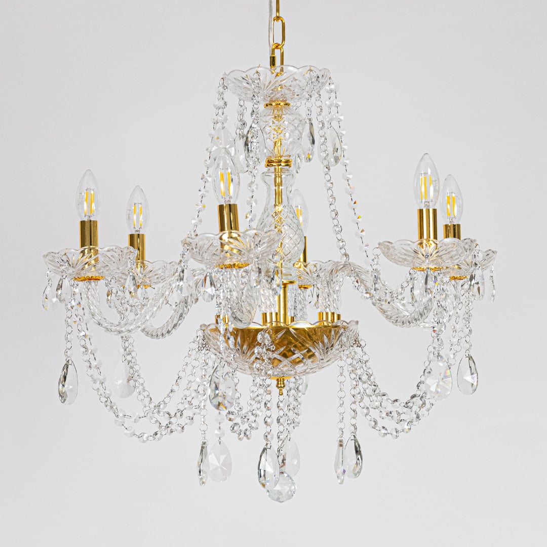 Gold metal crystal chandelier displayed on white background ideal for classic bright interior ceiling styling.