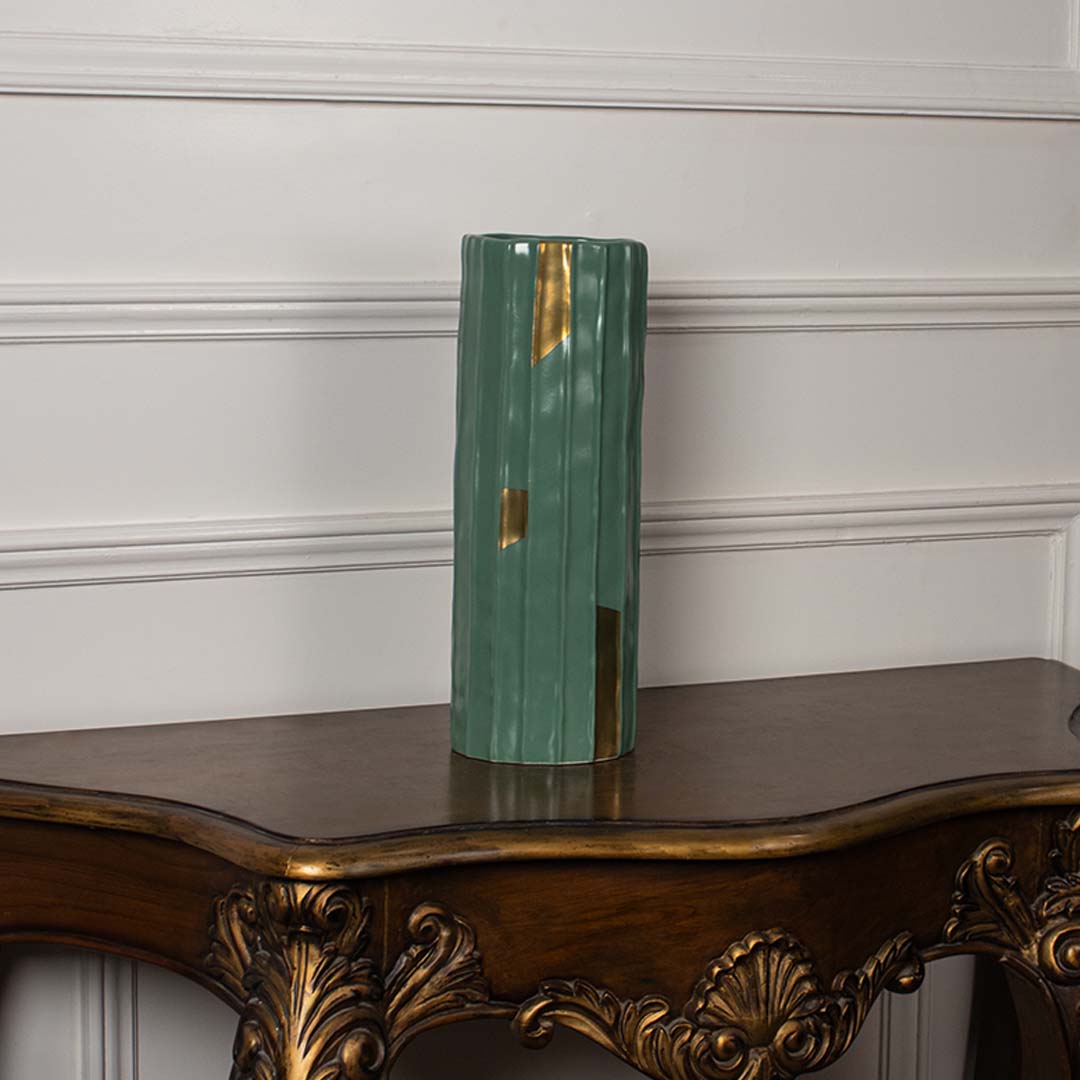 Tall green ribbed ceramic vase with subtle gold detailing shown on a plain white background perfect for minimal elegant interior styling.