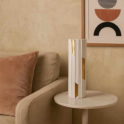 Tall modern vase with a white ribbed body and metallic gold accents styled in a minimal setting to highlight its elegant shape and refined contemporary look.