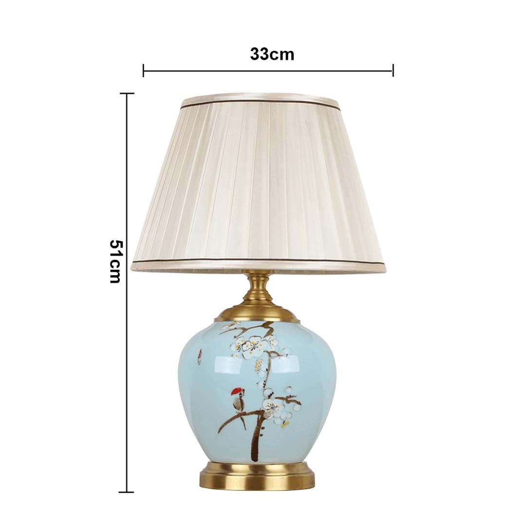 Table lamp with blue ceramic base and white pleated shade shown with 33 cm width and 51 cm height for accurate decor placement.