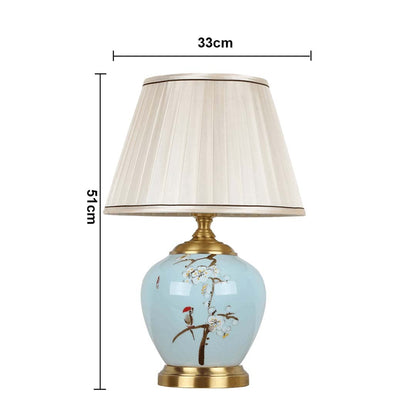 Table lamp with blue ceramic base and white pleated shade shown with 33 cm width and 51 cm height for accurate decor placement.