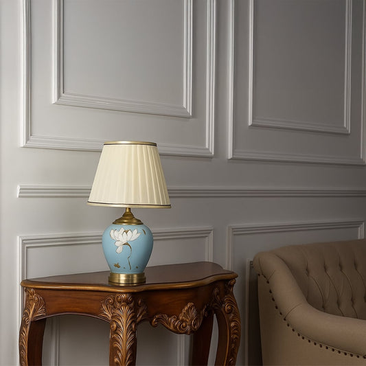 Elegant Lotus table lamp with ceramic base and pleated shade styled in a luxury living room decor.
