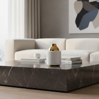 White ceramic vase set with gold and chrome tops styled on a wooden table creating a warm minimal decor look with soft dried stems adding natural elegance.
