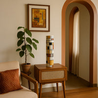 Modern geometric tall vase in warm earthy tones styled on a wooden side table in a cozy living room creating an artistic decor accent for contemporary interiors.