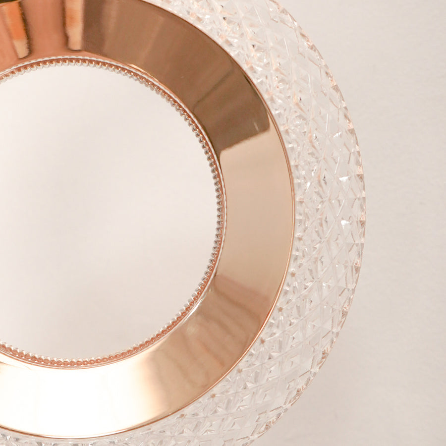 Detailed closeup of textured glass and rose gold metal ring led wall sconce pendant light fixture for modern home decor.