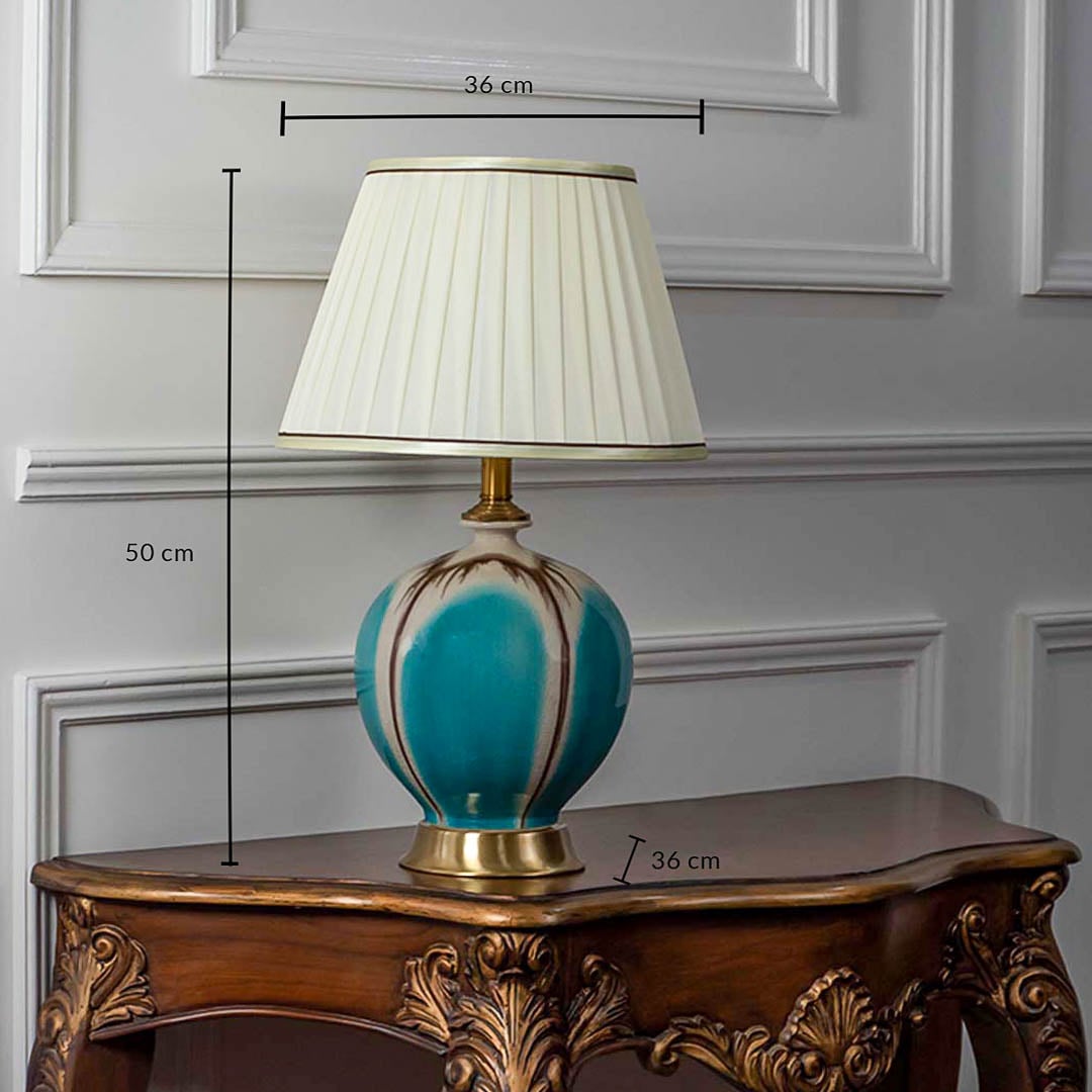 Turquoise ceramic table lamp with pleated white shade shown with size 50cm height and 36cm width on white background for product details.